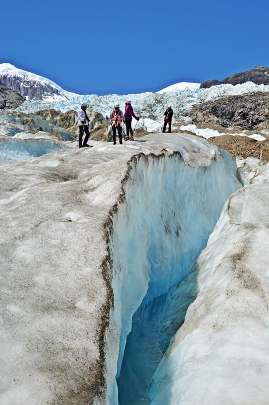 People standing next to the crevasse